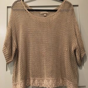Crochet sweater with lace hem.